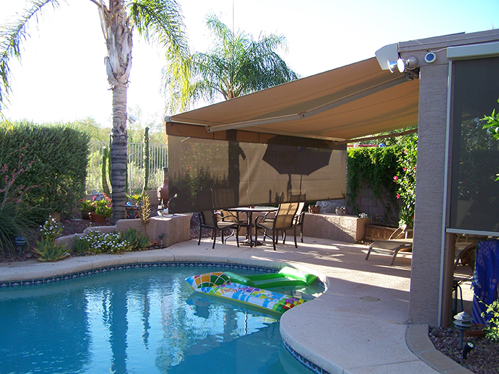 backyard with awning that has a long extended piece and there is a pool